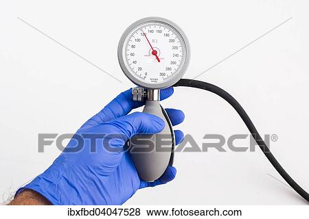 "A hand with a blue medical glove is holding a sphygmomanometer, blood pressure meter, indicating normal blood pressure" View Large Photo Image Stock Photo - "A hand with a blue medical glove is holding a sphygmomanometer, blood pressure meter, indicating normal blood pressure". Fotosearch