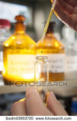 A laboratory worker using a pipette to fill a chemical liquid in a glass container View Large Photo Image Stock Image - A laboratory worker using a pipette to fill a chemical liquid in a glass container. Fotosearch