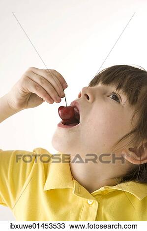 A little girl eating cherries View Large Photo Image Stock Image - A little girl eating cherries. Fotosearch
