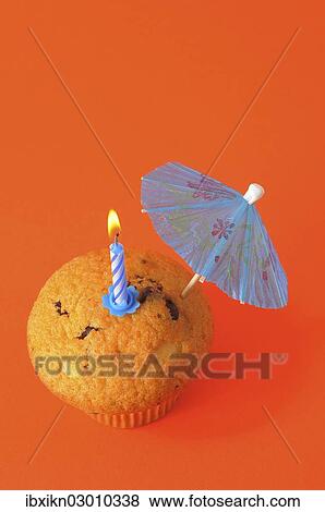 A muffin with a birthday candle and an umbrella View Large Photo Image Stock Photo - A muffin with a birthday candle and an umbrella. Fotosearch