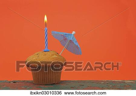 A muffin with a birthday candle and an umbrella View Large Photo Image Stock Photograph - A muffin with a birthday candle and an umbrella. Fotosearch