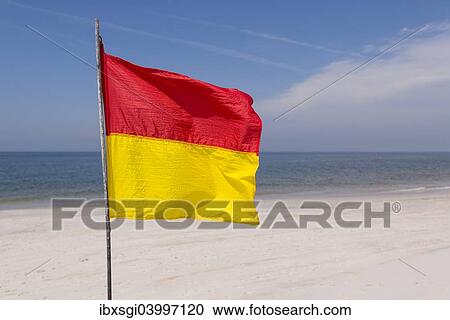 "A red-yellow flag waves on the beach, near Kampen, Sylt, Schleswig-Holstein, Germany, Europe" View Large Photo Image Stock Image - "A red-yellow flag waves on the beach, near Kampen, Sylt, Schleswig-Holstein, Germany, Europe". Fotosearch