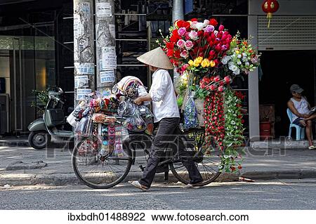 "A street vendor with a bicycle selling her flowers in Hanoi, Vietnam, Asia" View Large Photo Image Stock Image - "A street vendor with a bicycle selling her flowers in Hanoi, Vietnam, Asia". Fotosearch