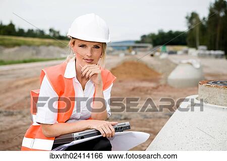 Stock Photograph - "A young female constructor at building of a new motorway, Germany, Europe". Fotosearch