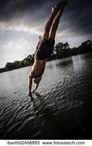 "A young man plunging into water from the riverside, Germany, Europe" View Large Photo Image Stock Image - "A young man plunging into water from the riverside, Germany, Europe". Fotosearch