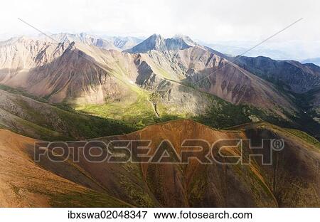 "Aerial of mineral-rich Northern Mackenzie Mountains, Peel Watershed, Yukon Territory, Canada, North America" View Large Photo Image Stock Photo - "Aerial of mineral-rich Northern Mackenzie Mountains, Peel Watershed, Yukon Territory, Canada, North America". Fotosearch