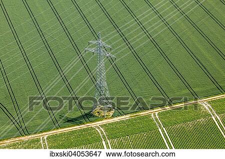 Stock Photo - "Aerial view, high-voltage transmission pylon on a green whaet field, Landshut, Lower Bavaria, Bavaria, Germany, Europe". Fotosearch