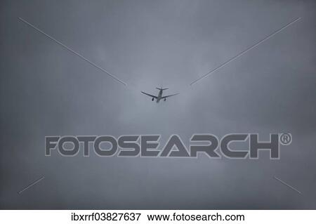 Aircraft flying through rain clouds View Large Photo Image Stock Photo - Aircraft flying through rain clouds. Fotosearch