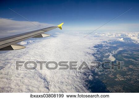 Stock Photo - "Aircraft in flight above a cloud front, Baden-Wurttemberg, Germany, Europe". Fotosearch