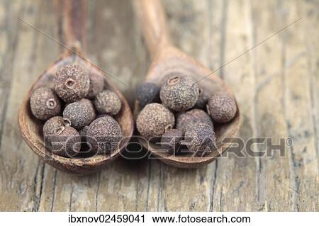 Stock Image - Allspice on Wooden Spoons. Fotosearch