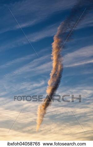 "Almost perpendicular cloud, contrail resolving, in the evening light, North Rhine-Westphalia, Germany, Europe" View Large Photo Image Stock Photography - "Almost perpendicular cloud, contrail resolving, in the evening light, North Rhine-Westphalia, Germany, Europe". Fotosearch