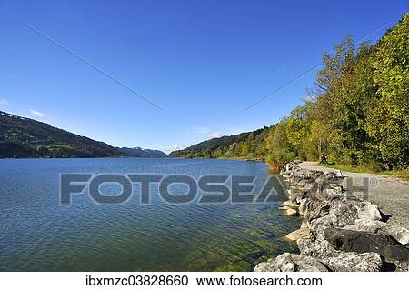 Stock Image - "Alpsee lake with a waterfront promenade, Buhl am Alpsee, Upper Allgau, Bavaria, Germany, Europe". Fotosearch