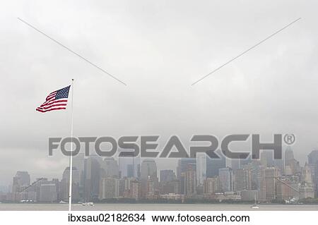 "American national flag, view from Ellis Island towards the skyline of Manhattan in the fog, New York, USA, North America" View Large Photo Image Picture - "American national flag, view from Ellis Island towards the skyline of Manhattan in the fog, New York, USA, North America". Fotosearch