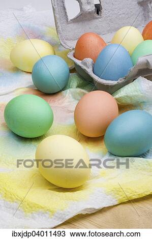 Stock Image - An assortment of colorful Easter eggs drying on paper towels. Fotosearch