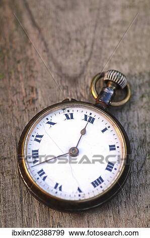 Antique pocket watch lying on a wooden table View Large Photo Image Stock Photo - Antique pocket watch lying on a wooden table. Fotosearch
