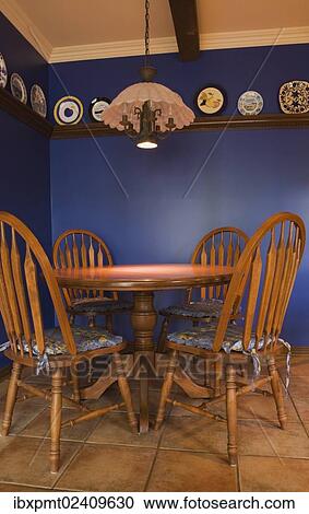Stock Image - "Antique table and chairs in the kitchen of a 1998 reproduction of an old Canadiana cottage style residential Home, Quebec, Canada, North America". Fotosearch