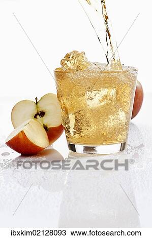 Apple juice being poured into a glass View Large Photo Image Stock Image - Apple juice being poured into a glass. Fotosearch
