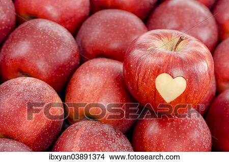 Apple with a heart shape cut-out View Large Photo Image Picture - Apple with a heart shape cut-out. Fotosearch