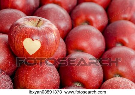 Apple with a heart shape cut-out View Large Photo Image Stock Image - Apple with a heart shape cut-out. Fotosearch