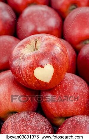 Apple with a heart shape cut-out View Large Photo Image Stock Photography - Apple with a heart shape cut-out. Fotosearch