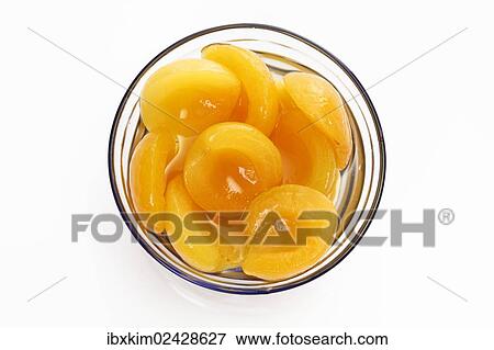 Apricot halves in a glass bowl View Large Photo Image Stock Photo - Apricot halves in a glass bowl. Fotosearch