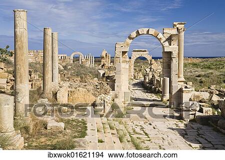Picture - "Arch of Trajan on Via Trionfale, Arch of Tiberius in the back, Leptis Magna, Libya, North Africa, Africa". Fotosearch