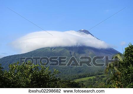 Stock Image - "Arenal volcano capped by a cloud, La Fortuna, Costa Rica, South America, North America". Fotosearch