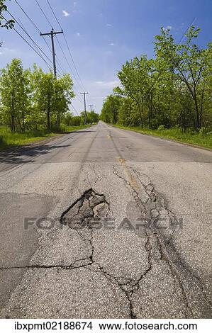 Picture - "Asphalt road with pothole in the countryside, Quebec, Canada, North America". Fotosearch