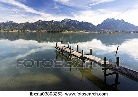 "Autumn mood with mountain views on Forggensee lake near Fussen, East Allgau, Bavaria, Germany, Europe" View Large Photo Image Stock Image - "Autumn mood with mountain views on Forggensee lake near Fussen, East Allgau, Bavaria, Germany, Europe". Fotosearch