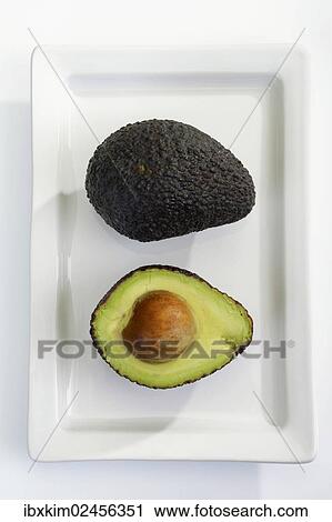 "Avocado (Persea americana), ripe, halved" View Large Photo Image Stock Image - "Avocado (Persea americana), ripe, halved". Fotosearch