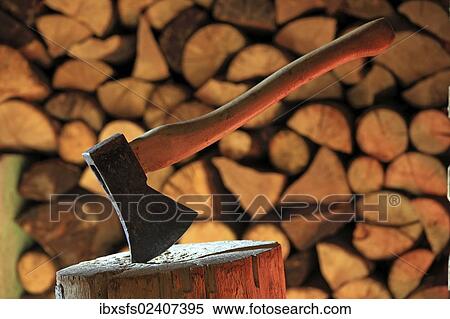 "Axe on a log, stacked firewood at the back" View Large Photo Image Stock Photography - "Axe on a log, stacked firewood at the back". Fotosearch