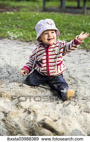"Baby, 12-14 Months, playing in the sand" View Large Photo Image Stock Photo - "Baby, 12-14 Months, playing in the sand". Fotosearch