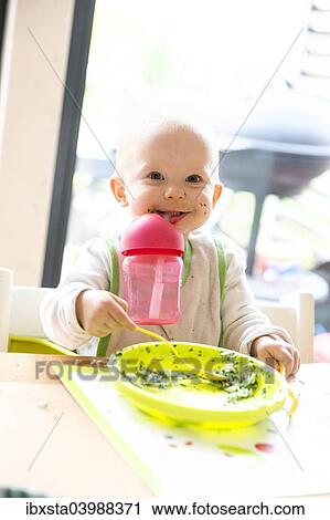 "Baby, 12-14 months, with drinking cup and plate" View Large Photo Image Stock Image - "Baby, 12-14 months, with drinking cup and plate". Fotosearch