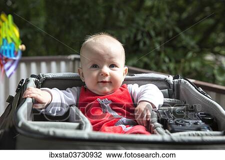 "Baby, 4-5 months old, in a bag, Germany, Europe" View Large Photo Image Stock Image - "Baby, 4-5 months old, in a bag, Germany, Europe". Fotosearch