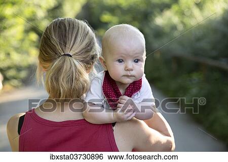 Stock Photograph - "Baby, 4-5 months old, on its mother's arm, Germany, Europe". Fotosearch