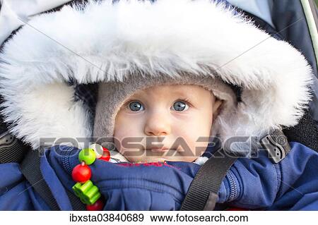 Stock Photo - "Baby, 9 months, wearing a thick jacket". Fotosearch