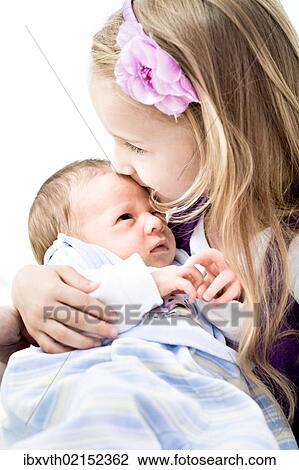 Stock Image - "Baby boy, 1 month, being held by his sister". Fotosearch