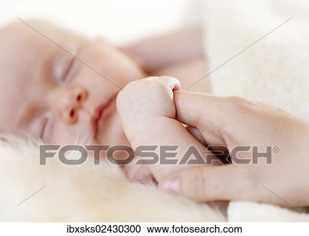 "Baby girl, 3 months, lying on a sheepskin, holding her mother's finger" View Large Photo Image Stock Image - "Baby girl, 3 months, lying on a sheepskin, holding her mother's finger". Fotosearch