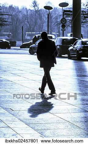 "Backlit image of a man crossing the street, Berlin, Germany, Europe" View Large Photo Image Stock Image - "Backlit image of a man crossing the street, Berlin, Germany, Europe". Fotosearch