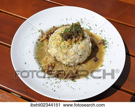Stock Image - "Bacon dumpling with sauerkraut, Ruhpolding, Chiemgau, Bavaria, Germany, Europe". Fotosearch