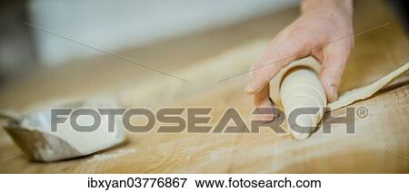 Stock Photo - "Baking rolls, hand shaping dough". Fotosearch