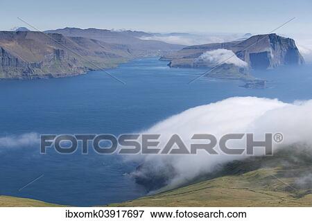 "Bank of clouds over Vagar and Mykines, Utoyggjar, Faroe Islands, Denmark, Europe" View Large Photo Image Stock Photo - "Bank of clouds over Vagar and Mykines, Utoyggjar, Faroe Islands, Denmark, Europe". Fotosearch