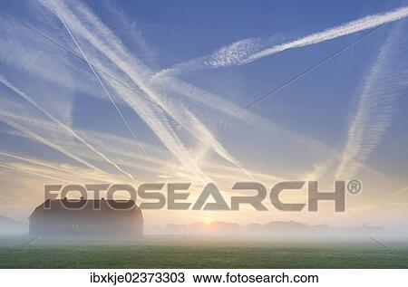 "Barn, condensation trails in the sky, sunrise in Basse, Lake Mariensee, Neustadt am Ruebenberge, Lower Saxony, Germany, Europe" View Large Photo Image Stock Image - "Barn, condensation trails in the sky, sunrise in Basse, Lake Mariensee, Neustadt am Ruebenberge, Lower Saxony, Germany, Europe". Fotosearch