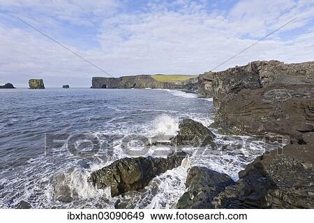 "Basalt cliffs and a rock arch on the coast, Dyrholaey, Vik i Myrdal, Southern Region, Iceland, Europe" View Large Photo Image Stock Photo - "Basalt cliffs and a rock arch on the coast, Dyrholaey, Vik i Myrdal, Southern Region, Iceland, Europe". Fotosearch