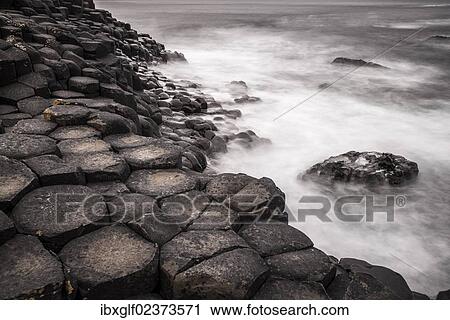 "Basaltic rocks on the shore with waves, Giant's Causeway, Coleraine, Northern Ireland, United Kingdom, Europe" View Large Photo Image Stock Image - "Basaltic rocks on the shore with waves, Giant's Causeway, Coleraine, Northern Ireland, United Kingdom, Europe". Fotosearch