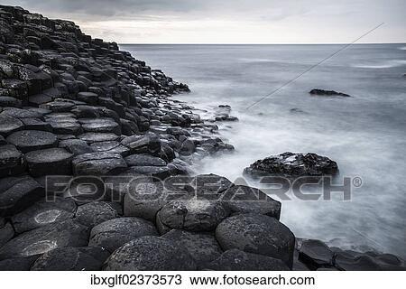 "Basaltic rocks on the shore with waves, Giant's Causeway, Coleraine, Northern Ireland, United Kingdom, Europe" View Large Photo Image Stock Image - "Basaltic rocks on the shore with waves, Giant's Causeway, Coleraine, Northern Ireland, United Kingdom, Europe". Fotosearch