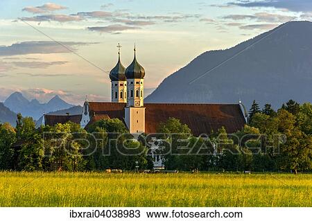 "Basilica of St Benedict, Benedictine monastery Benediktbeuern, rear right Herzogstand of the Alps, in the back Arnspitze Group in Wetterstein range of the Alps, Benediktbeuern, Upper Bavaria, Bavaria, Germany, Europe" View Large Photo Image Stock Image - "Basilica of St Benedict, Benedictine monastery Benediktbeuern, rear right Herzogstand of the Alps, in the back Arnspitze Group in Wetterstein range of the Alps, Benediktbeuern, Upper Bavaria, Bavaria, Germany, Europe". Fotosearch