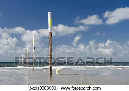 "Beach and marker posts against the sky, St Peter-Ording, Schleswig-Holstein, Germany, Europe" View Large Photo Image Stock Photo - "Beach and marker posts against the sky, St Peter-Ording, Schleswig-Holstein, Germany, Europe". Fotosearch