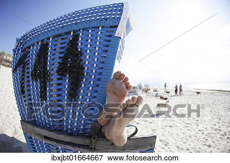 "Beach chair, feet, beach, Langeoog island, East Frisian Islands, North Sea, Germany, Europe" View Large Photo Image Stock Photo - "Beach chair, feet, beach, Langeoog island, East Frisian Islands, North Sea, Germany, Europe". Fotosearch