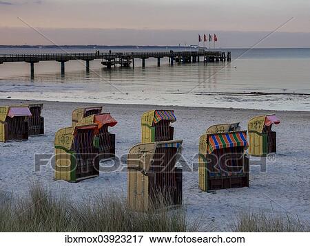 "Beach chairs on the beach at dusk, the pier at the back, Bay of Lubeck, Baltic Sea, Scharbeutz, Schleswig-Holstein, Germany, Europe" View Large Photo Image Stock Photo - "Beach chairs on the beach at dusk, the pier at the back, Bay of Lubeck, Baltic Sea, Scharbeutz, Schleswig-Holstein, Germany, Europe". Fotosearch